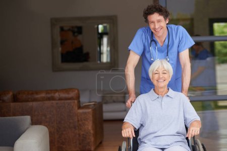 Photo for Taking care of his patients overall wellbeing. a doctor pushing his senior patient in a wheelchair - Royalty Free Image