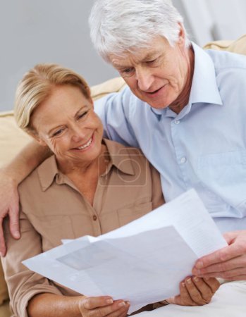 Photo for We did good this month. a happy senior couple looking at documents together - Royalty Free Image