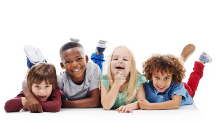 Photo for Diversity, children and happy friends or fun on the floor together or against a white background and hug. Smile, kids and playful or laughing and isolated in studio or excited buddies and embrace. - Royalty Free Image