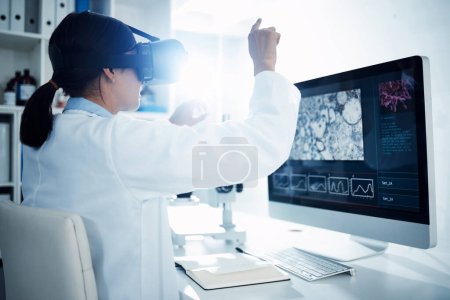 Foto de Llevar la ciencia directamente al futuro. un científico que utiliza un auricular de realidad virtual mientras realiza investigaciones en un laboratorio - Imagen libre de derechos