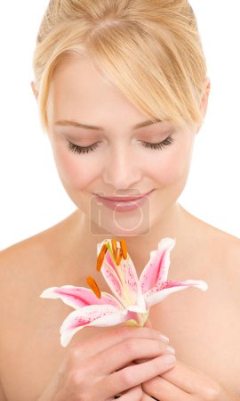 Photo for She is so sweet. Studio shot of a beautiful young woman holding a tiger lily - Royalty Free Image
