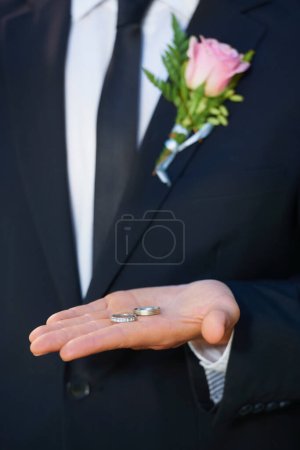 Photo for Giving the rings to his best man. Cropped closeup of a groom with the two wedding rings in the palm of his hand - Royalty Free Image