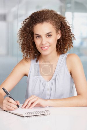 Photo for I still like to write down my ideas. A young businesswoman writing on a notepad - Royalty Free Image