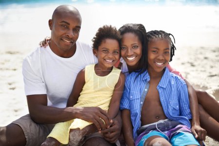 Photo for Loving family enjoying their vacation. A loving african-american family enjoying a day on the beach together - Royalty Free Image