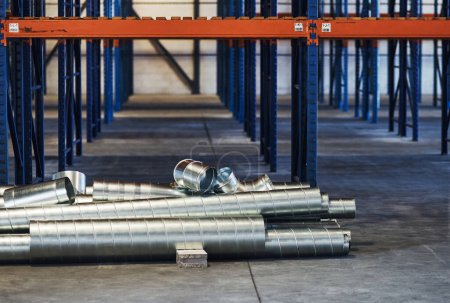 Photo for These need to be packed. metal sheets and pipes in an empty warehouse during the day - Royalty Free Image