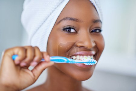 Because your pearly whites deserve to be pampered. a beautiful young woman during her daily beauty routine