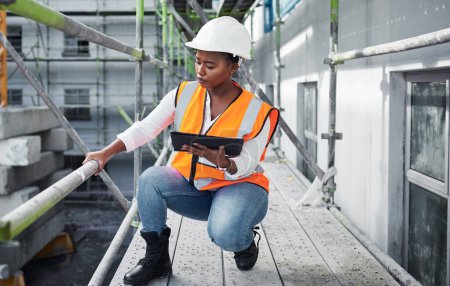 Photo for Building developments done digitally. a young woman using a digital tablet while working at a construction site - Royalty Free Image