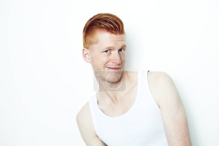 Photo for Portrait, doubt and a ginger man in studio isolated on a white background wearing a tank top. Face, confused and question with a young male person indoor on mockup looking skeptical in a vest. - Royalty Free Image