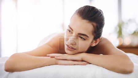 Foto de No puedo evitar pensar que necesito otro día de spa. Primer plano de una joven que se relaja en una cama de spa - Imagen libre de derechos