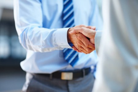 Photo for Youve got yourself a deal. two people shaking hands in a corporate environment - Royalty Free Image