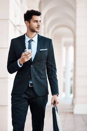 Photo for Look the part, be the part. a young handsome businessman using a cellphone outside - Royalty Free Image