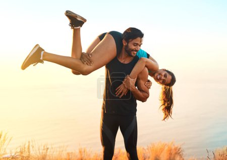Photo for Working out together will make you and your relationship stronger. a sporty couple being playful while out for a workout - Royalty Free Image
