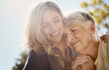 Photo for Family, love or smile with a senior mother and daughter bonding outdoor together during a summer day. Happy, flare and retirement with a young man hugging her elderly parent outside in the park. - Royalty Free Image