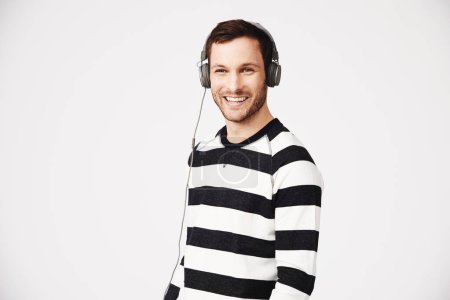Photo for Man, portrait and headphones with music and podcast with happiness and listening. Isolated, white background and male person hearing web audio and song streaming with a happy smile in studio. - Royalty Free Image