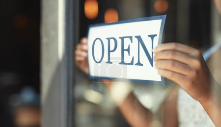 Photo for Open sign, restaurant window and hands of person, small business owner or manager with cafe door poster for welcome. Retail sales waitress, coffee shop barista and closeup board for store service. - Royalty Free Image