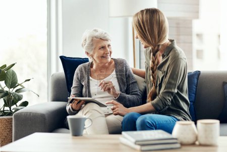 Photo for So I can stay in contact with whoever is connected. a senior woman and her daughter using a digital tablet together - Royalty Free Image
