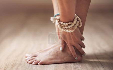 Photo for Feeling grounded through practice. an unrecognizable woman standing alone and stretching while holding her feet in a yoga studio - Royalty Free Image