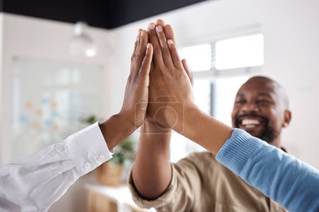 Photo for Motivation is necessary to achieve greatness. a group of businesspeople giving each other a high five in a modern office - Royalty Free Image