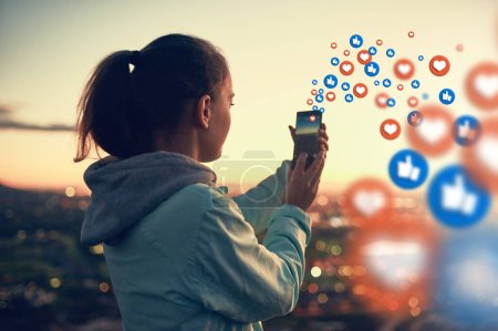 Photo for Social media emoticons, sunset or woman taking a photo of view for photography content or online post. Nature, icon overlay or girl on mobile app, website or network with love, like or heart emoji. - Royalty Free Image