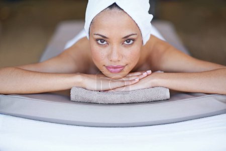 Photo for Shes ready to be pampered. Portrait of a young woman lying on a massage table - Royalty Free Image