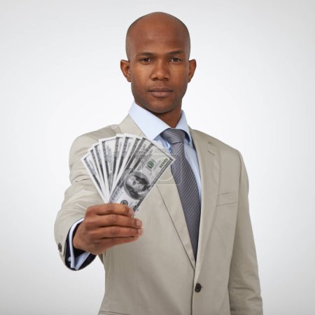 Photo for This success could be yours too. A handsome businessman showing you a wad of cash while isolated on a white background - Royalty Free Image
