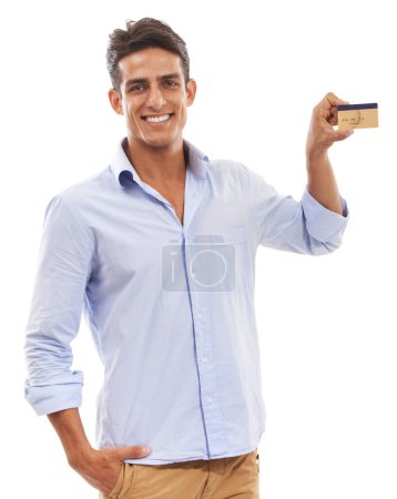 Photo for My credit card is great. Portrait of a handsome young man holding a credit card and smiling - Royalty Free Image