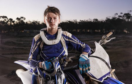 Photo for His bike is his best friend. Portrait of a young motocross rider posing on his bike - Royalty Free Image