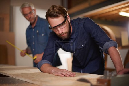 Photo for Hes an aspiring carpenter. a father and son working together on a carpentry project in a workshop - Royalty Free Image