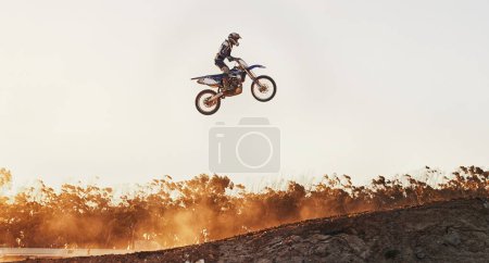 Photo for Leaving the track in his mirrors. A shot of a motocross rider in midair during a race - Royalty Free Image