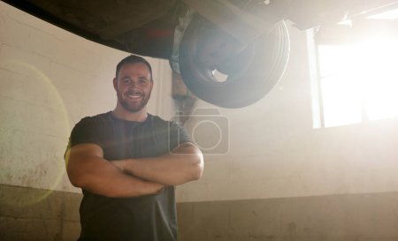 Photo for I have loyal customers who come to see me on a regular basis. a mechanic working under a lifted car - Royalty Free Image