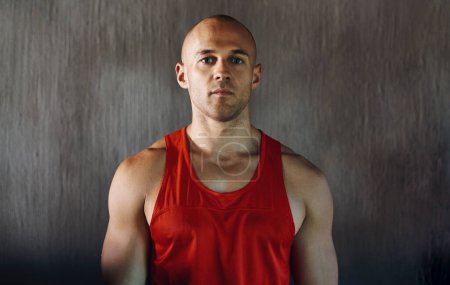 Photo for Workout, serious and portrait of man confident with determined mindset, gym commitment or discipline. Athlete focus, bodybuilder confidence and healthy fitness person on concrete wall background. - Royalty Free Image