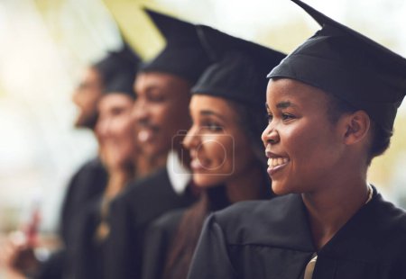 Photo for Its a bright future ahead of us. a group of fellow students standing in a row on graduation day - Royalty Free Image