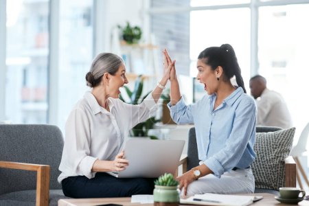 Photo for We made it happen. two businesswomen giving each other a high five while working together in an office - Royalty Free Image
