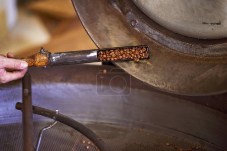 Photo for The humble beginnings of coffee. a machine grinding and roasting coffee beans - Royalty Free Image
