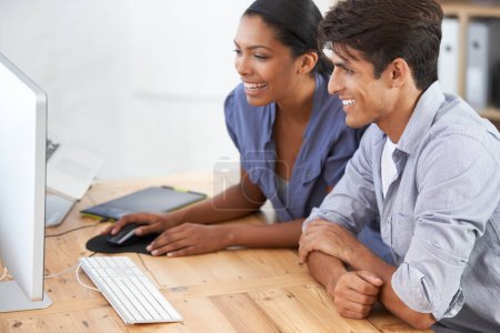 Foto de Estás progresando mucho. dos jóvenes colegas usando un ordenador - Imagen libre de derechos