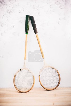 Photo for Lightweight just like the pros love. two squash racquets leaning against the wall in a squash court - Royalty Free Image