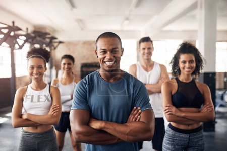Photo for Were here to keep you motivated. Portrait of a group of confident young people working out together in a gym - Royalty Free Image