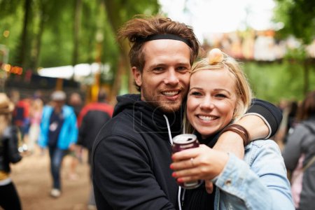 Photo for Good times. Portrait of a young man and woman hugging while outside at a music festival - Royalty Free Image