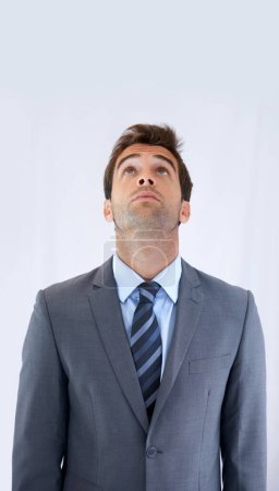 Photo for Seeking inspiration from above. A businessman standing and looking up with copyspace - Royalty Free Image
