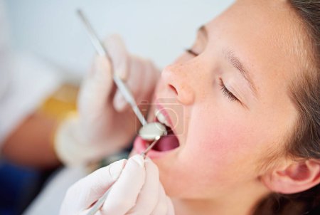 Photo for Your teeth are in perfect shape. Closeup shot of a young girl having a checkup at the dentist - Royalty Free Image