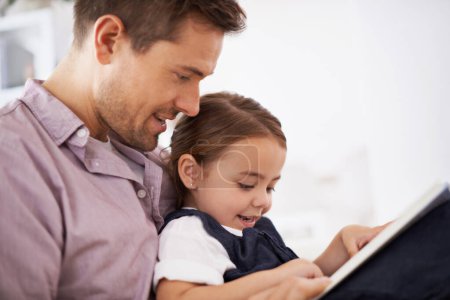 Getting lost in imagination. a young father reading a book with his daughter
