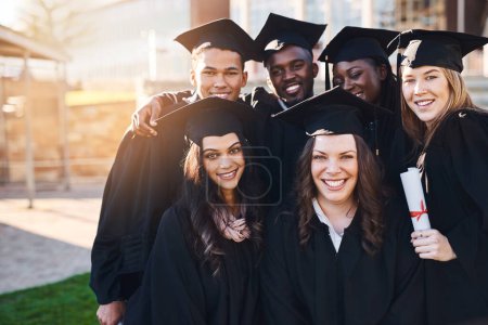 Photo for Tomorrow belongs to those who prepare for it. Portrait of a group of students standing together on graduation day - Royalty Free Image