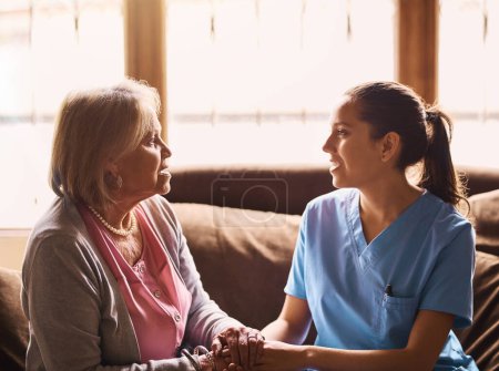 Photo for Caring for seniors is a labor of love. a nurse holding a senior womans hands in comfort - Royalty Free Image