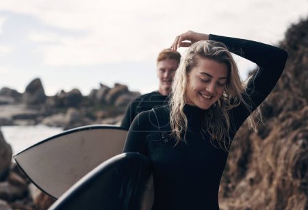Photo for You feel so much better after spending time on the waves. a young couple out surfing together at the beach - Royalty Free Image