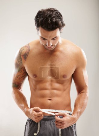 Photo for Abs, healthy or man with tape measure for fitness after body workout isolated on white background. Male model, six pack goal or sexy athlete after stomach muscle exercise or training to lose weight. - Royalty Free Image