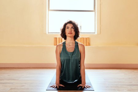 Photo for Get to know your inner yogi. a young woman practicing the cobra pose during a yoga session - Royalty Free Image