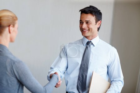 Photo for Welcome aboard...A young businessman shaking hands with a female coworker - Royalty Free Image