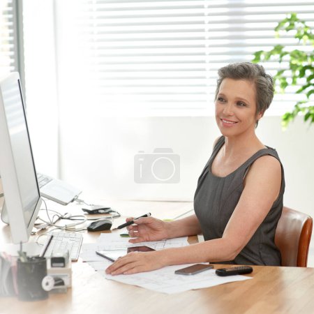 Photo for I think these plans are coming along nicely. A mature female architect at work in her office - Royalty Free Image