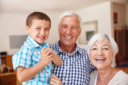Photo for He loves visiting grandma and grandpa. a young boy with his grandparents - Royalty Free Image