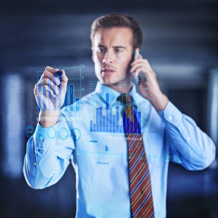 Photo for Calculating risks in a digital age. a handsome young businessman using a digital interface - Royalty Free Image